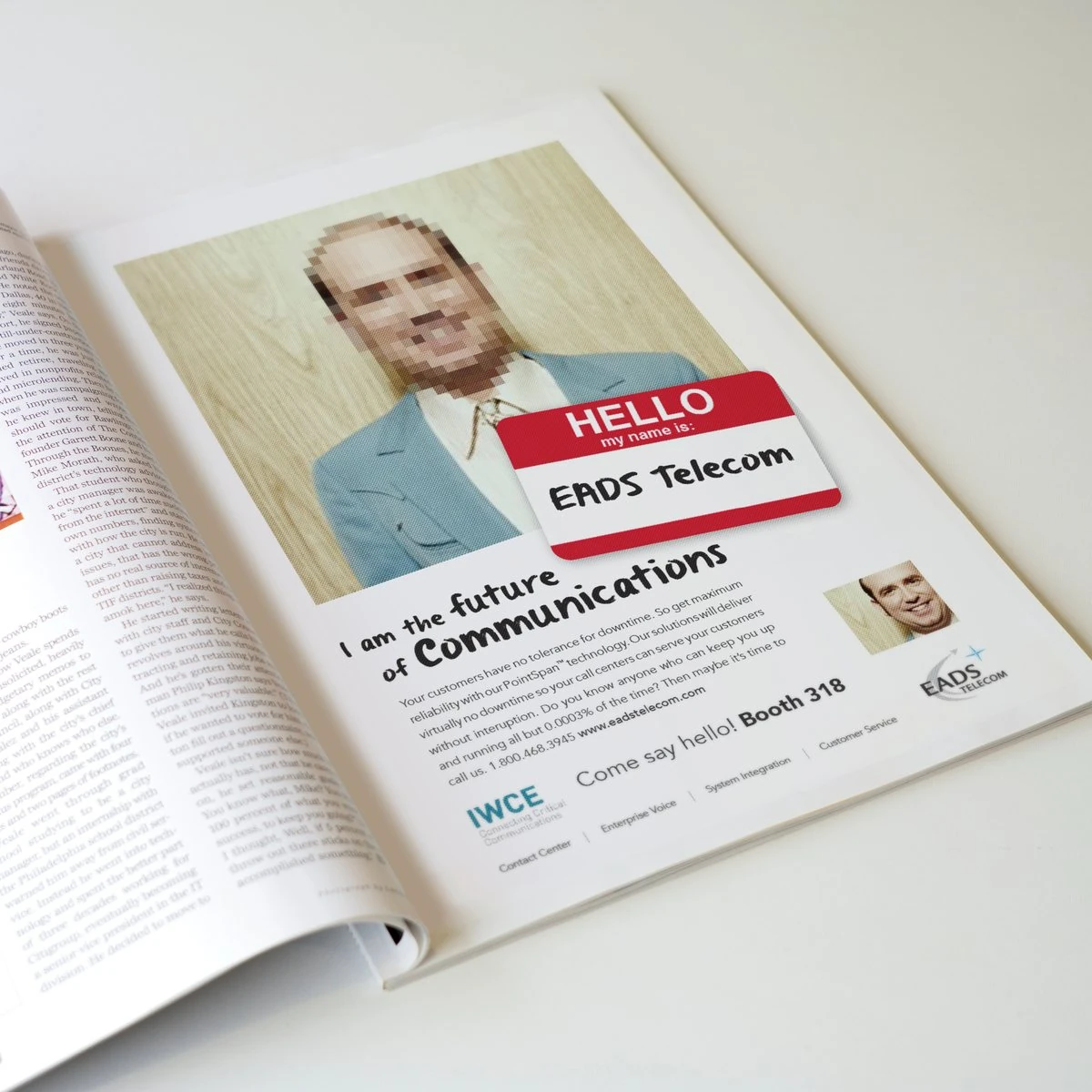EADS Telecom magazine ad “I am the future of communications” with a pixelated man in a blue suit and a Booth 318 call-out