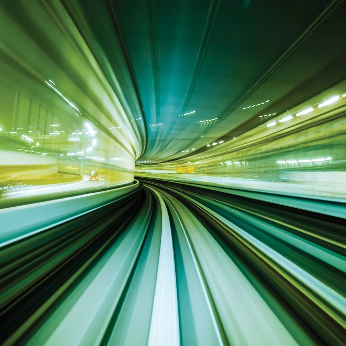 Green motion-blurred light trails rushing through a curved tunnel