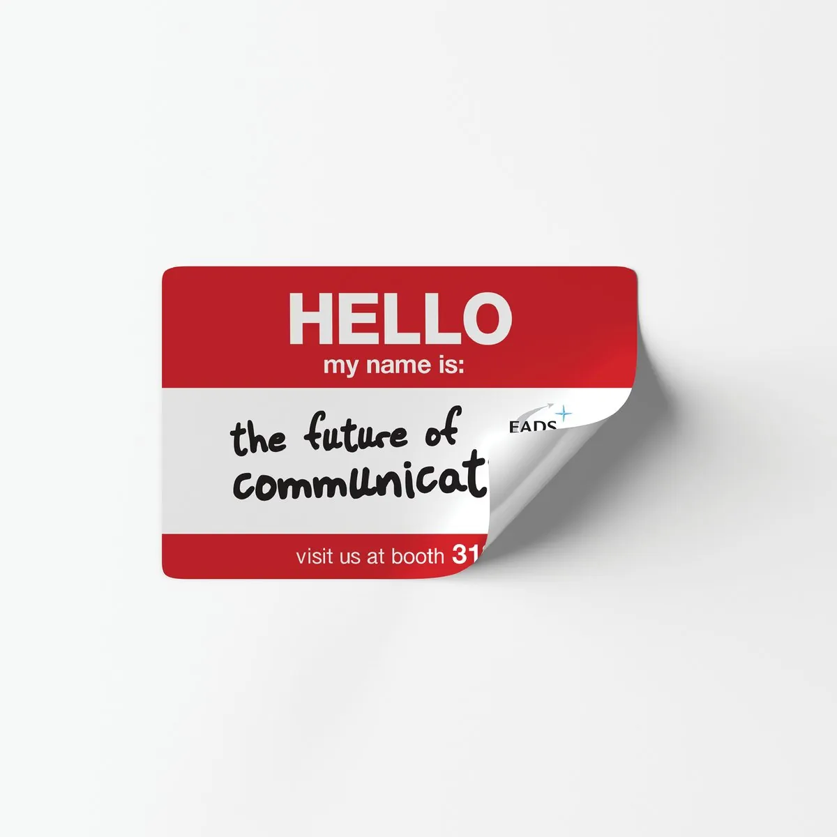 Peeling red name tag sticker reading “Hello, my name is: the future of communications, visit us at booth”