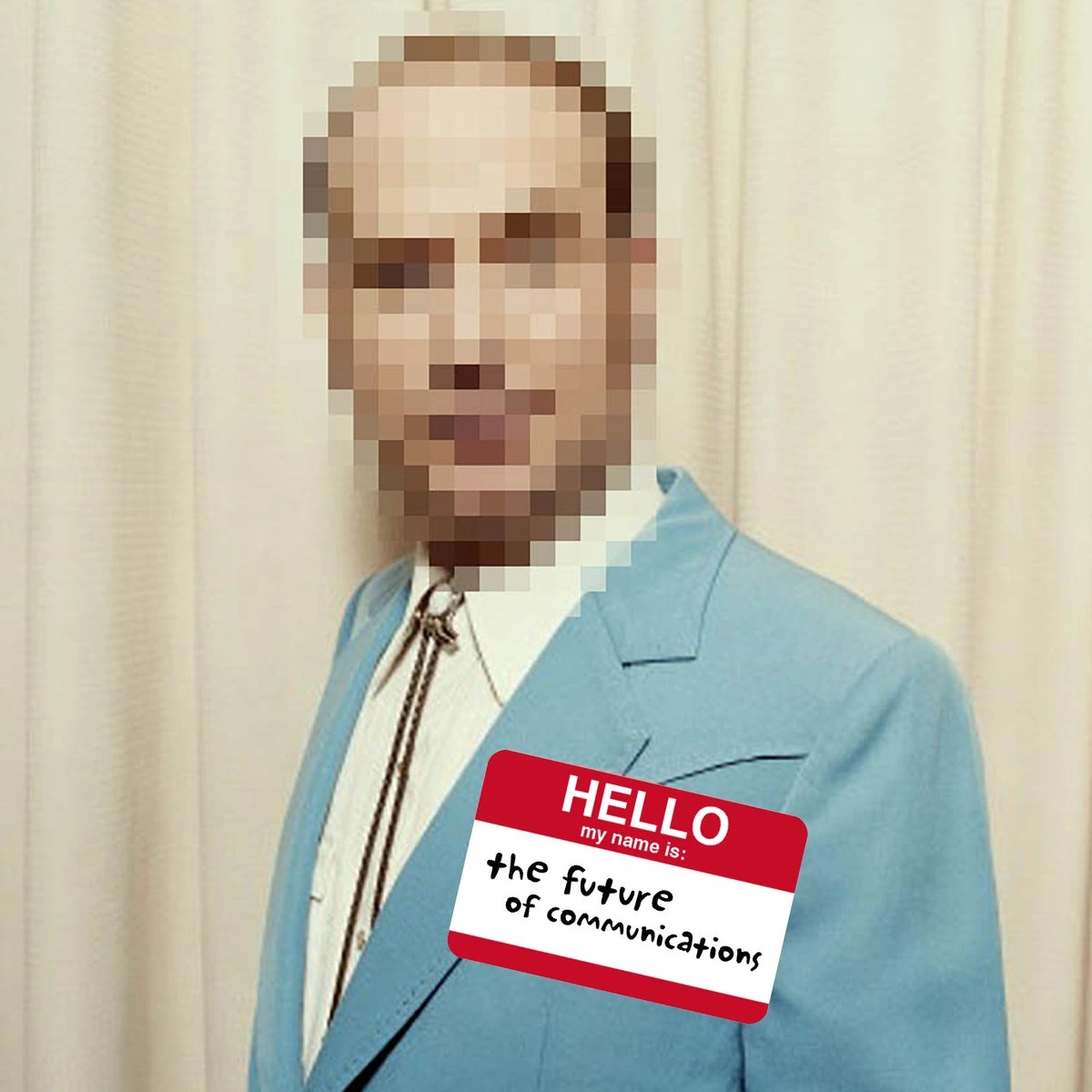 A man in a powder-blue suit and bolo tie, face pixelated, wearing a “Hello, my name is: the future of communications” name tag