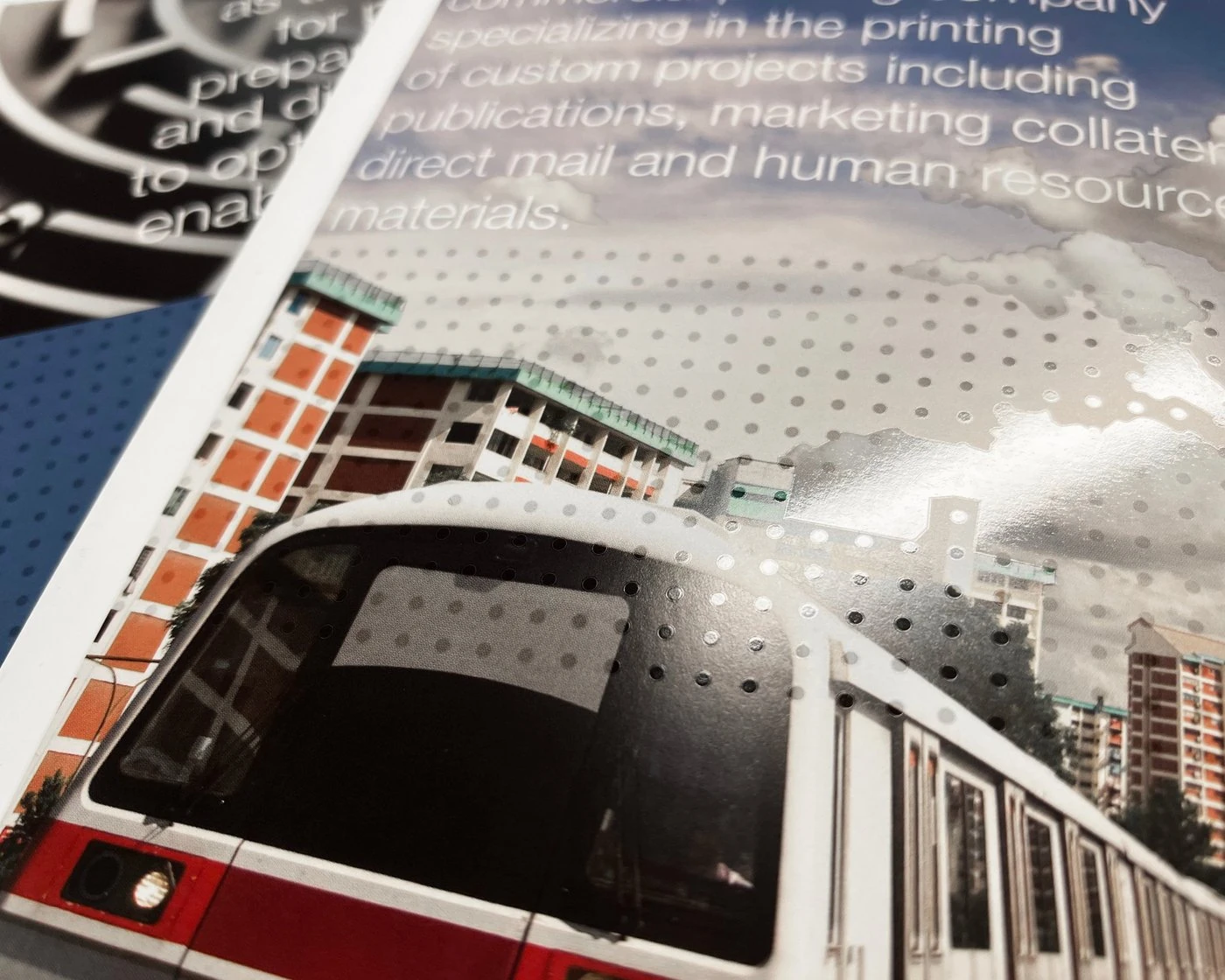 Close-up of the train panel with glossy spot-varnish dots over the sky