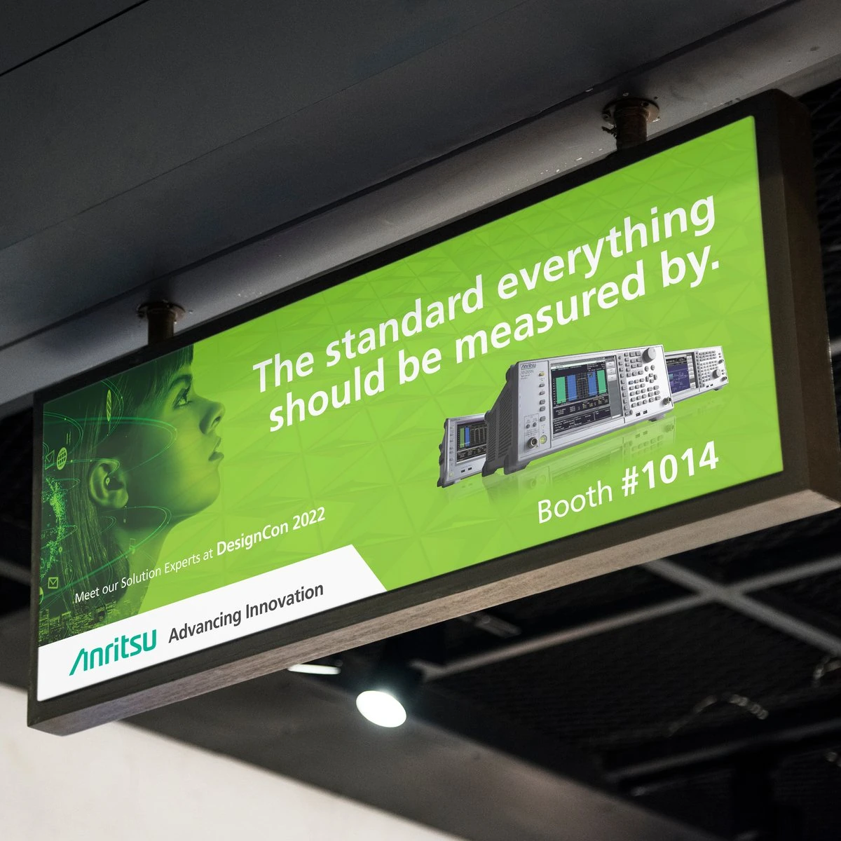 Green hanging sign “The standard everything should be measured by.” for Anritsu at DesignCon 2022