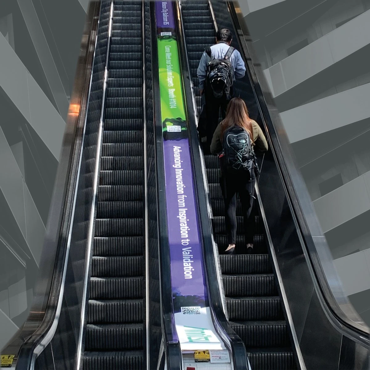 Purple and green Anritsu escalator wrap reading “Advancing Innovation from Inspiration to Validation”