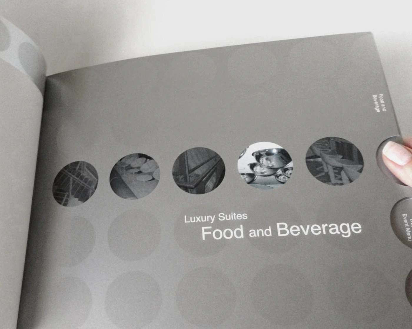Food and Beverage divider page with five photo circles and round edge tabs, held open by a hand