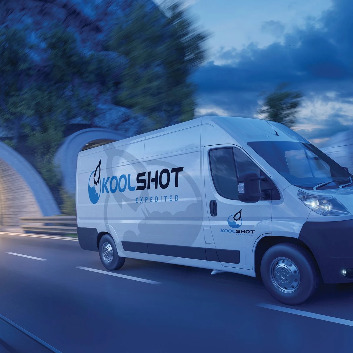 White KoolShot Expedited sprinter van speeding out of a tunnel at dusk