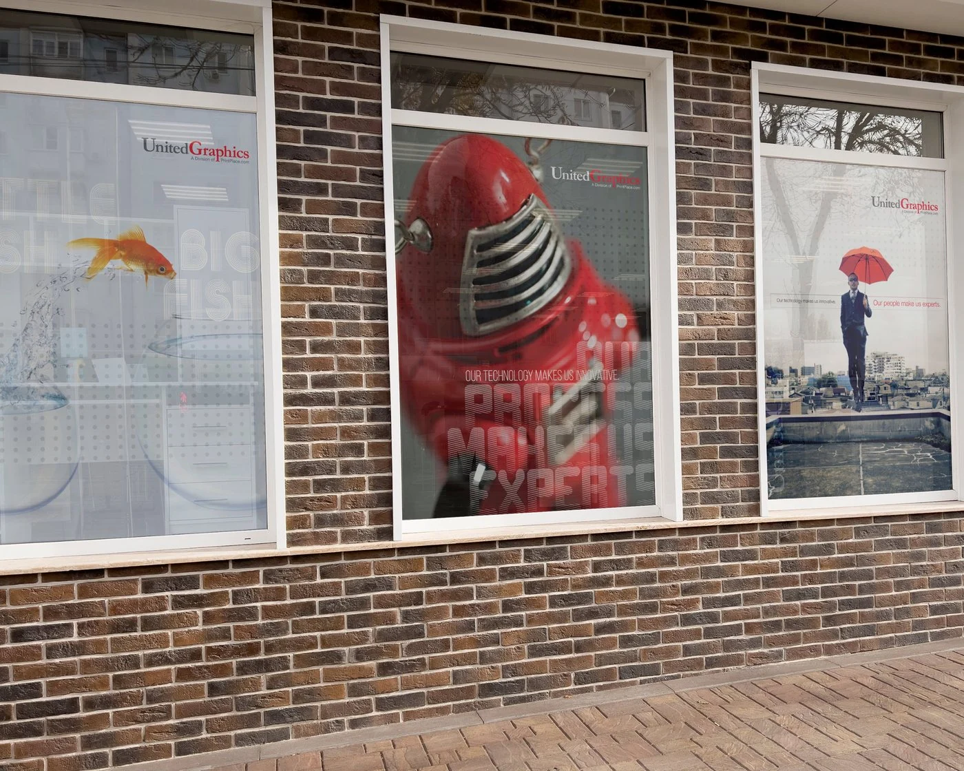 United Graphics window graphics on a brick storefront