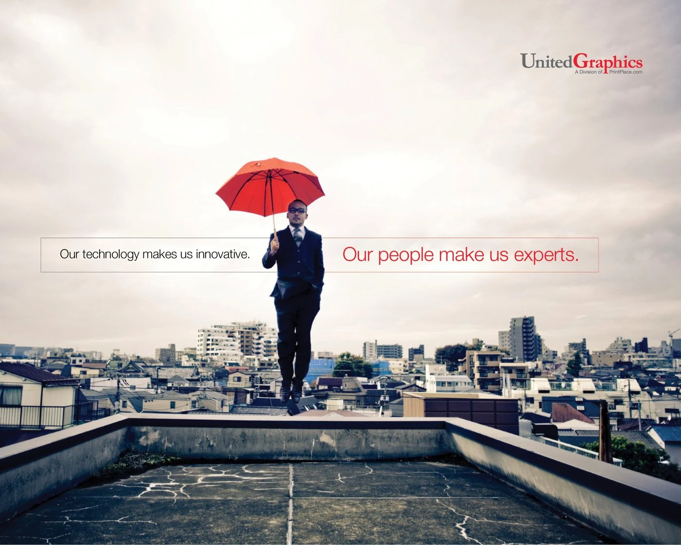 United Graphics ad: a man in a suit floating above a rooftop with a red umbrella, between the lines “Our technology makes us innovative. Our people make us experts.”