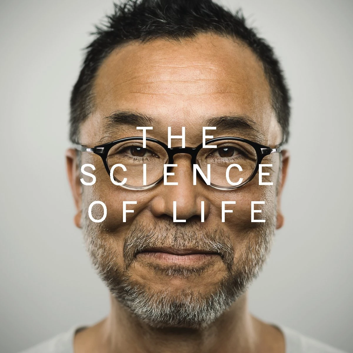 Portrait of a man in round glasses with “The Science of Life” across his face