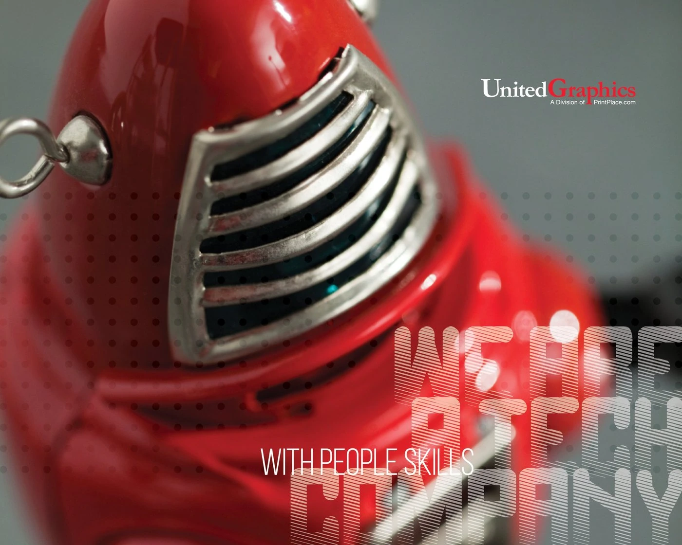 United Graphics ad: a close-up of a red toy robot with the lines “We are a tech company with people skills”