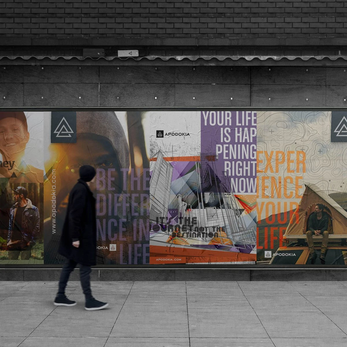 A pedestrian walks past a wall of APODOKIA campaign posters