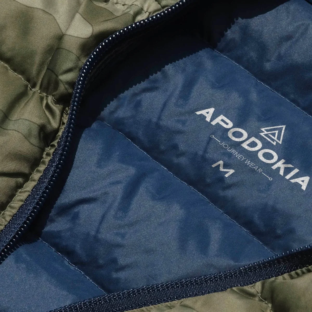 APODOKIA Journey Wear logo printed inside a navy jacket lining, size M