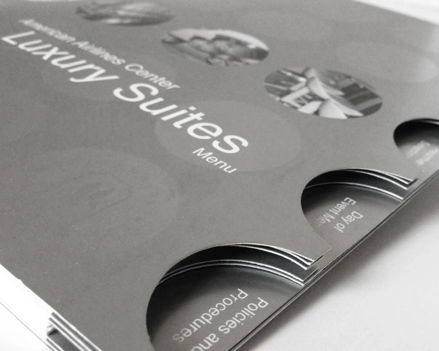 Angled view of the cover’s round die-cut tabs labeled Policies and Procedures and Day of Event Menu