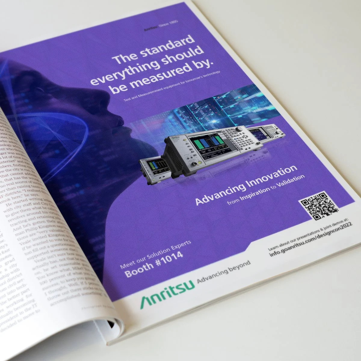 Purple Anritsu DesignCon ad “The standard everything should be measured by.” printed in an open magazine