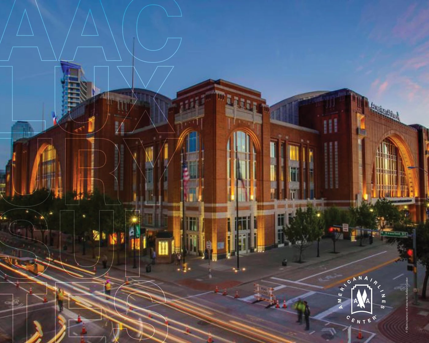 The American Airlines Center at dusk, with outlined “AAC Luxury Suites” lettering and the arena seal