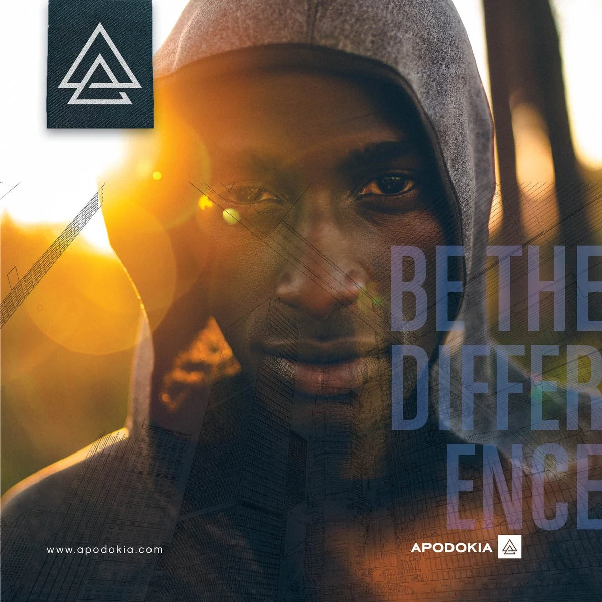 APODOKIA “Be the Difference” graphic: a man in a grey hood lit by a golden sunset